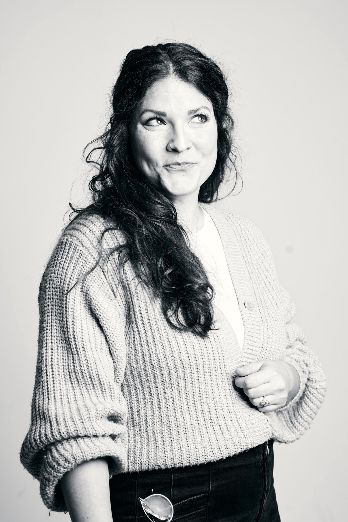 Black-and-white portrait of Leah in a knitted cardigan