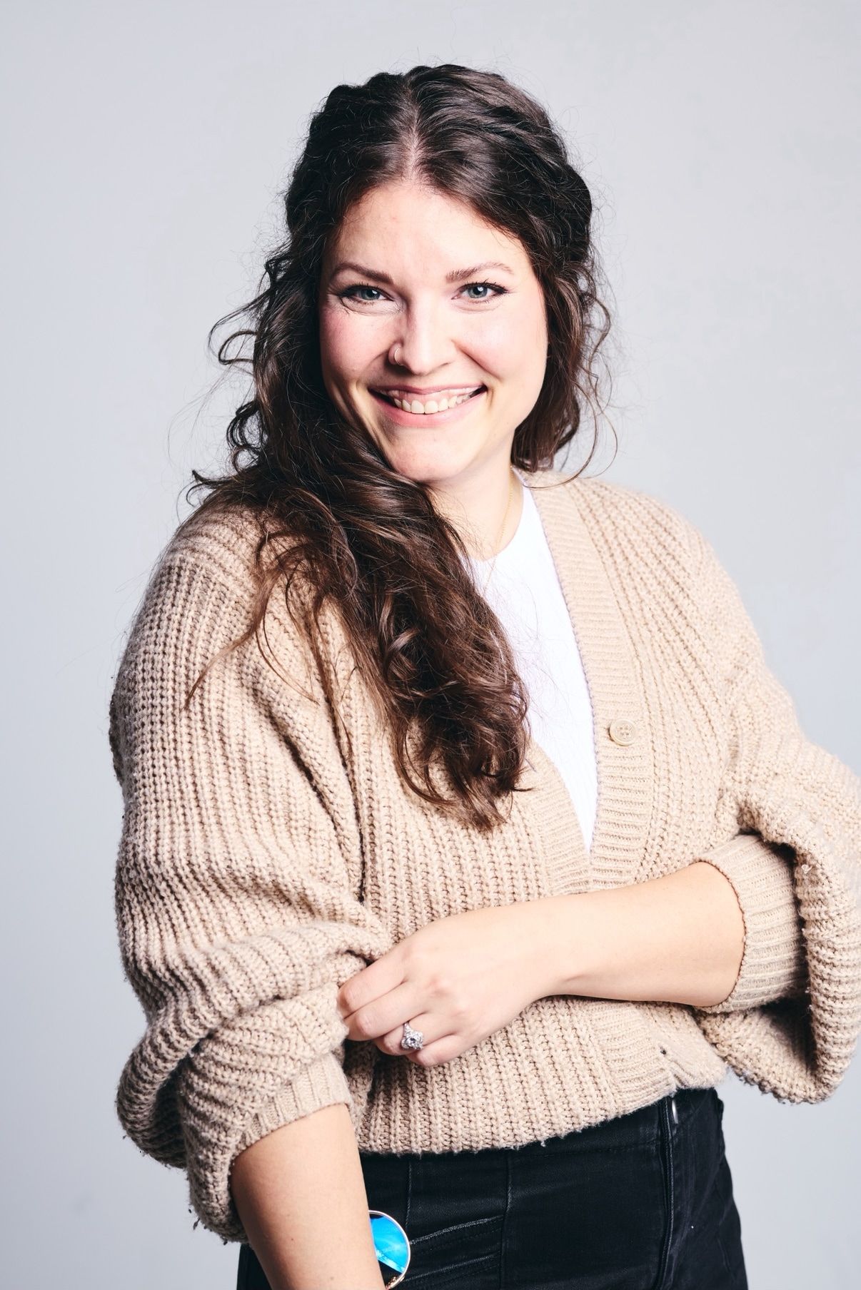 Leah smiling in a cream cardigan